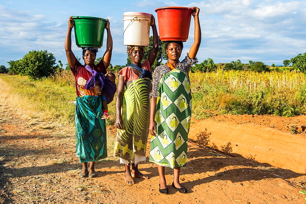 Women Carrying Water Where It All Started For Hippo Roller Hippo Roller   Malawi Women Carrying Water 1 